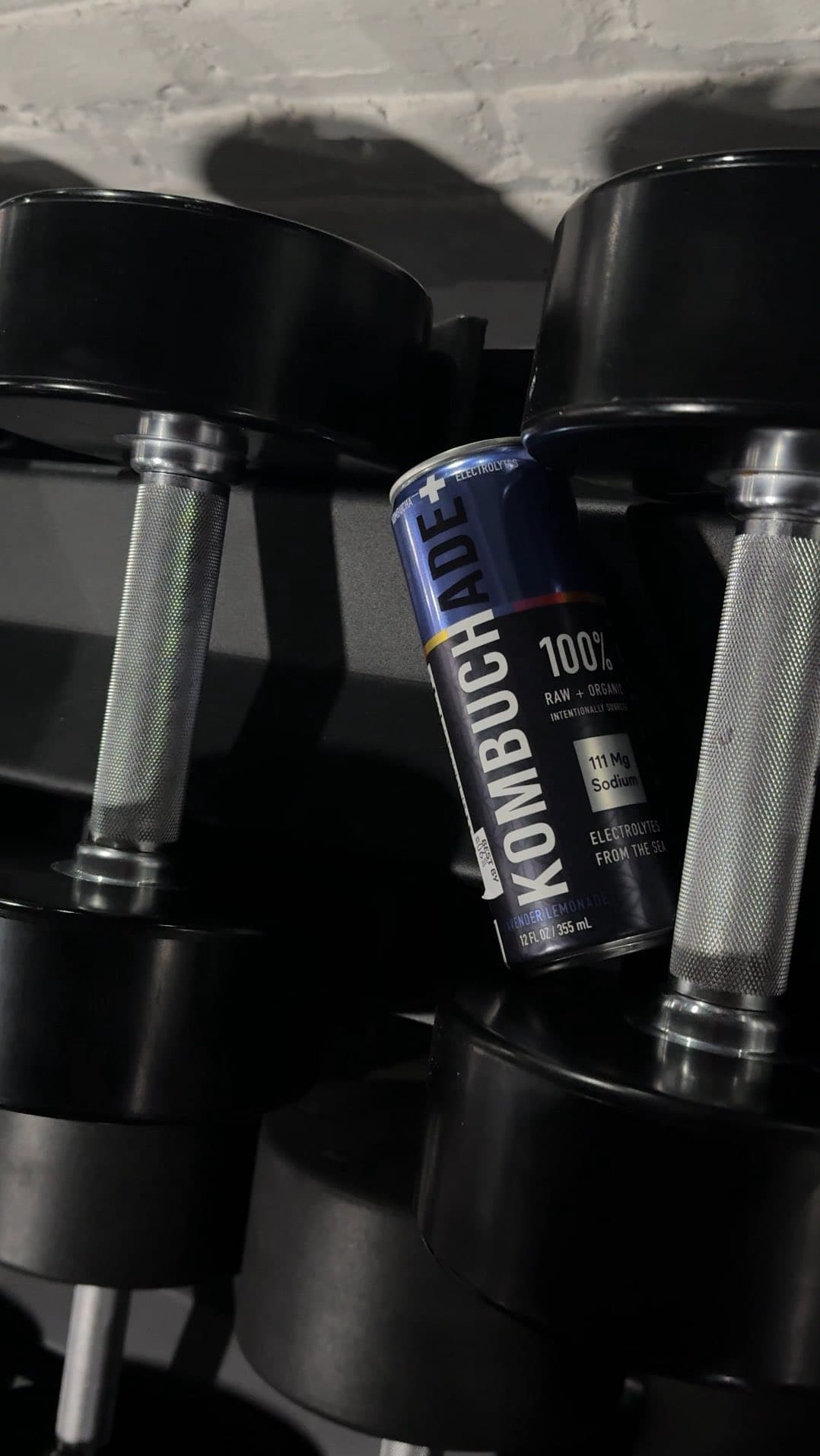 Kombuchade can resting on the dumbbell rack